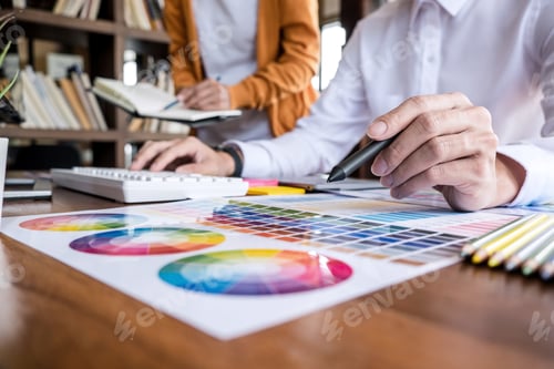 Preview: Two Colleagues Creative Graphic Designer Working On Color Selection And Drawing On Graphics Tablet