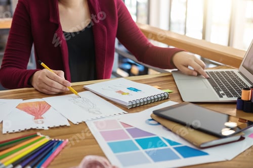Preview: Young Woman Designer Working As Fashion Designers At Work With Fashion Sketches And Color Charts