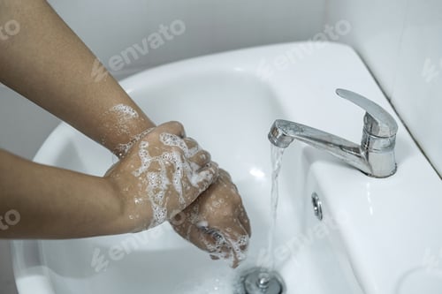 Preview: Woman Washing Hands Under The Water Tap In Bathroom With Using Soap Gel For Cleaning And Prevention