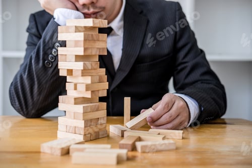 Preview: Images Of Hand Of Businesspeople Placing And Pulling Wood Block On The Tower, Alternative Risk