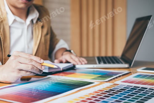 Preview: Creative Graphic Designer Using Graphics Tablet To Choosing Color Swatch Samples Chart For