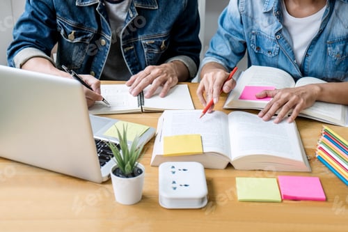 Preview: High School Tutor Or College Student Group Sitting At Desk In Library Studying And Reading, Doing
