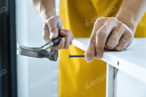 Preview: Craftsman Doing Renovation Work At Home Improvement With Using Hammer To Driving Nail On Wood And