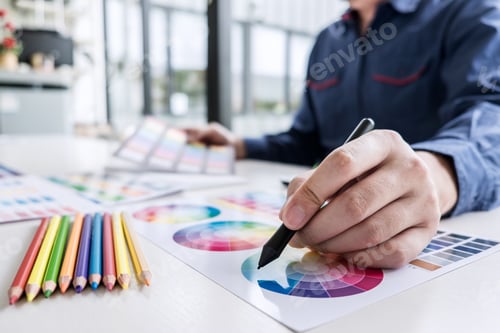 Preview: Image Of Male Creative Graphic Designer Working On Color Selection And Drawing On Graphics Tablet
