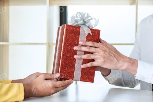 Vista previa: Couple Giving Gift Box To Each Other With Birthday Greeting Or Celebration Day And Christmas.