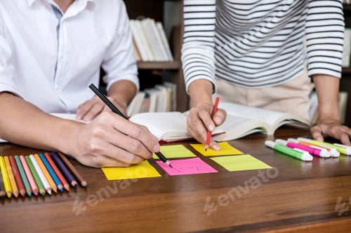 Preview: High School Or College Student Group Sitting At Desk In Library Studying And Reading, Doing