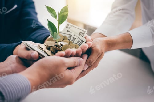 Preview: Hands Of Business Team Holding Plant Sprouting Growing From Golden Coins And Banknotes, Business