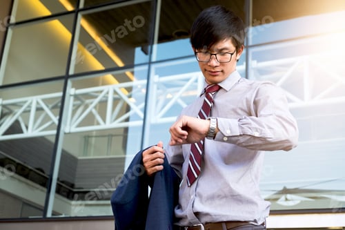 Preview: Executive In A Hurry, Businessman Looking At His Watch On Hand, Checking The Time While Standing On