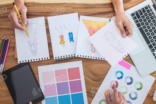 Preview: Two Young Professional Fashion Designer Colleagues Working And Project Of Drawing Sketches For