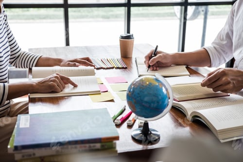 Preview: High School Or College Student Group Sitting At Desk In Library Studying And Reading, Doing