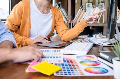 Preview: Two Colleague Creative Graphic Designer Working On Color Selection And Color Swatches, Drawing On