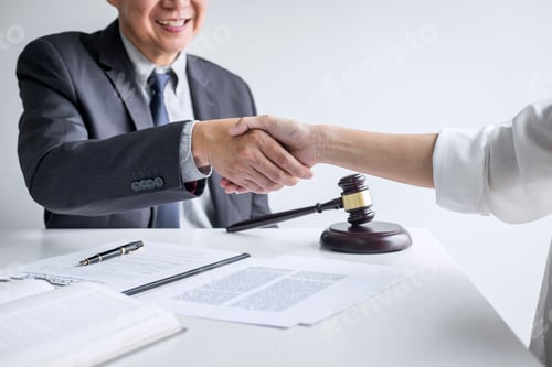 Preview: Business Agreement with Handshake at Office Desk