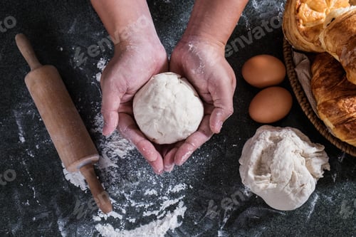 Preview: Hands Preparing Bread Dough, Raw Dough For Bread With Ingredients On Black Background.
