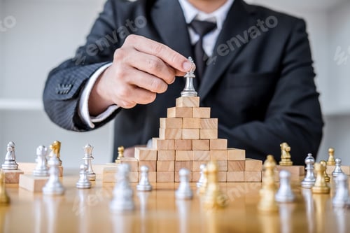 Preview: Wooden Game Of Strategy, Hands Of Confident Businessman Playing Chess Game To Development Analysis
