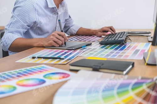 Preview: Image Of Male Creative Graphic Designer Working On Color Selection And Drawing On Graphics Tablet