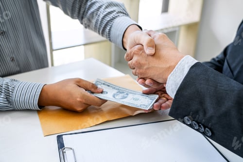 Preview: Businessmen Handshaking with Money Transfer at the Office