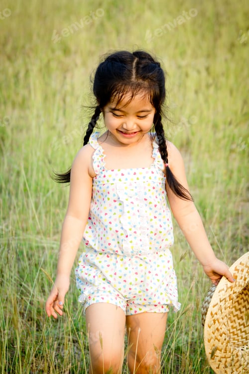 Preview: Little Asian Girl With Hat In The Field
