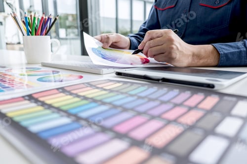 Preview: Male Creative Graphic Designer Working On Color Selection And Color Swatches, Drawing On Graphics
