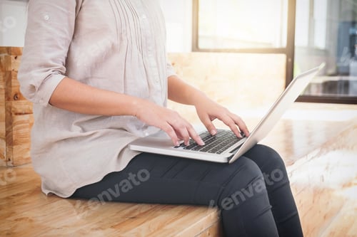 Preview: Young Business Woman Sitting In Modern Office, Working On A Laptop Computer And Planning A New