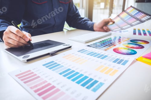 Preview: Male Creative Graphic Designer Working On Color Selection And Color Swatches, Drawing On Graphics