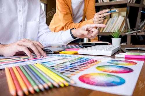 Preview: Two Colleagues Creative Graphic Designer Working On Color Selection And Drawing On Graphics Tablet