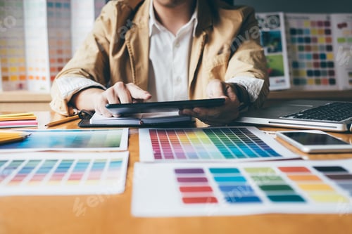 Preview: Young Creative Graphic Designer Using Graphics Tablet To Choosing Color Swatch Samples Chart For