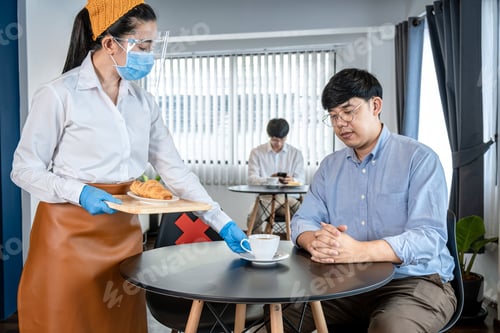 Preview: Asian Woman Waitress Serving Coffee And Bread To Client While Wearing Face Mask And Face Shield