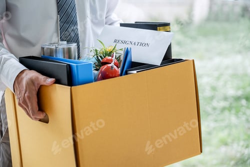 Preview: Images Of Businessman Carrying Packing Up All His Personal Belongings And Files Into A Brown
