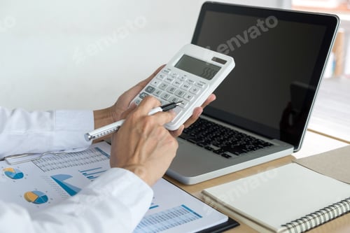 Preview: Female Accountant Calculations And Analyzing Financial Graph Data With Calculator And Laptop