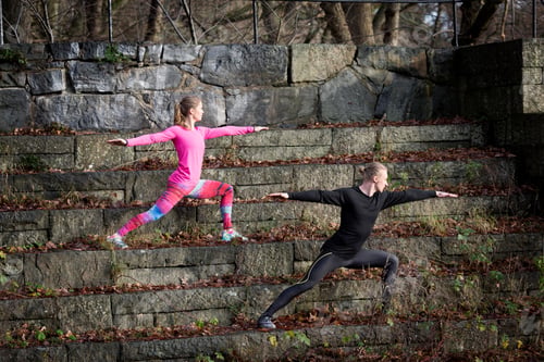 Preview: Couple On Stone Steps In Lunge Stance Arms Open Stretching, Looking Away