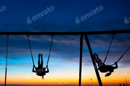 Preview: Children Playing On Swing At Sunset, Seaside Park, New Jersey, Usa