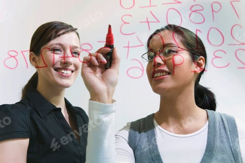 Preview: Two Women Work On Figures On Glass Wall