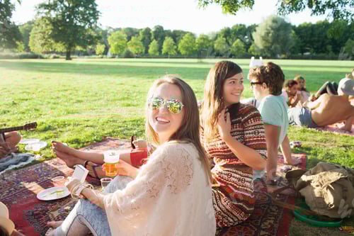 Preview: Happy Young Woman And Friends At Sunset Park Party