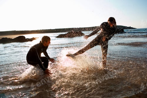 Preview: Couple In Wetsuits Splashing