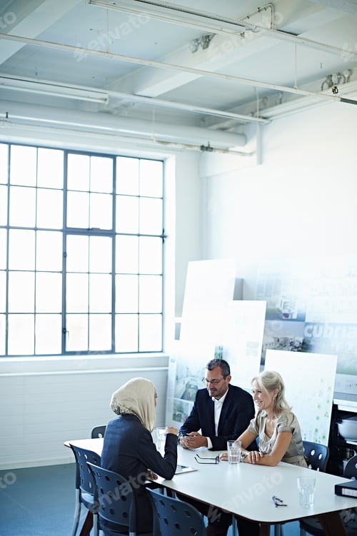 Preview: Two Businesswomen And Man Talking At Office Meeting