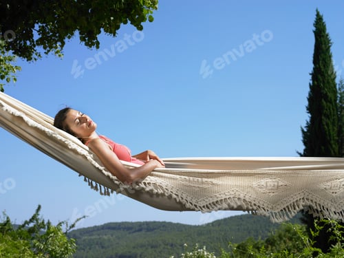 Preview: Woman Relaxing Peacefully in a Hammock Outside