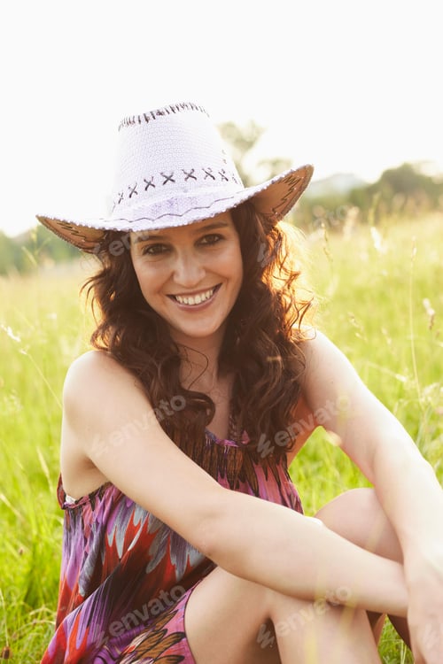 Preview: Woman With Hat Sitting In Meadow