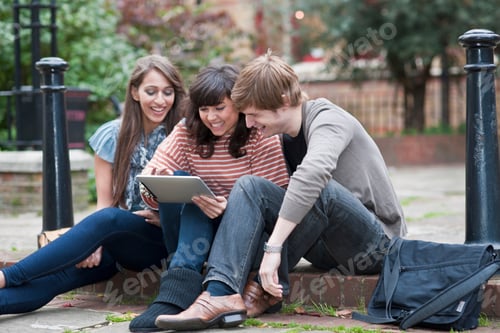 Preview: Friends Sharing Laptop Outside