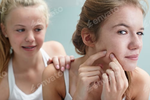 Preview: Girl Squeezing A Spot, Friend With Hand On Shoulder