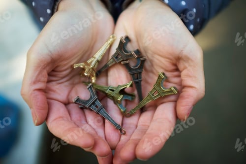 Preview: Young Woman Holding Eiffel Tower Souvenirs In Hand, Close-Up
