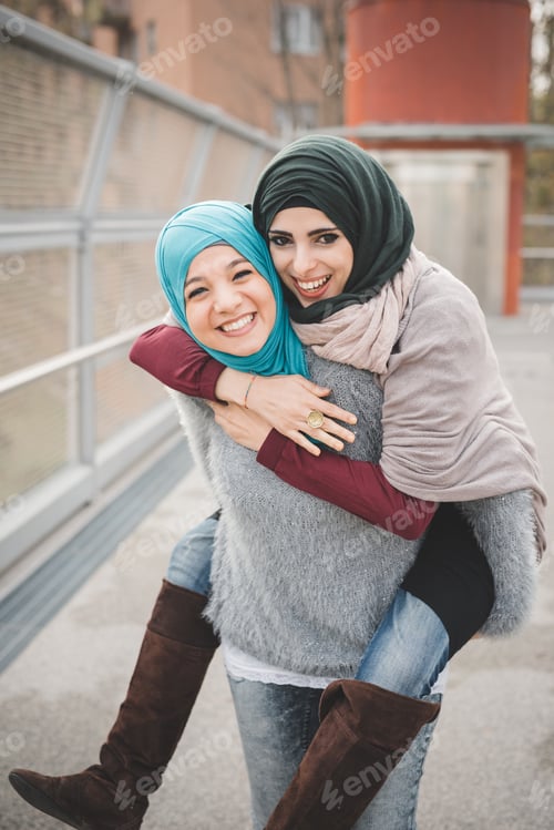 Preview: Young Woman Giving Piggyback To Friend
