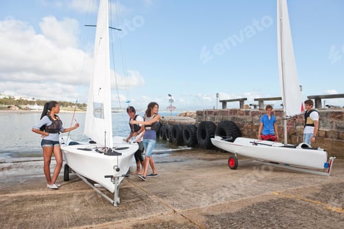 Preview: Young Adult Friends Preparing Sailboats On Waterfront