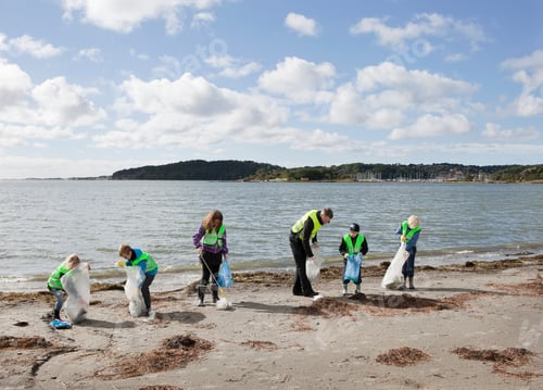 Preview: Man And Children Cleaning Beach