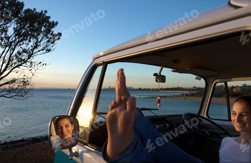 Preview: Young Woman With Feet Up On Camper Van Window