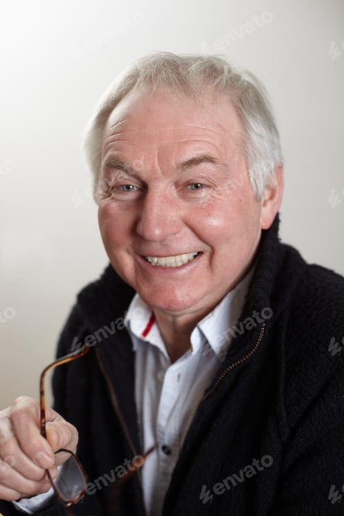 Preview: Close Up Portrait Of Senior Man Holding Spectacles
