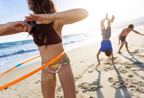 Preview: Group Of Friends Fooling Around On Beach