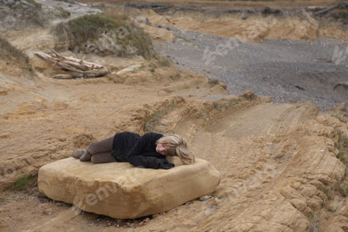 Preview: Girl Resting On Rock In Desert