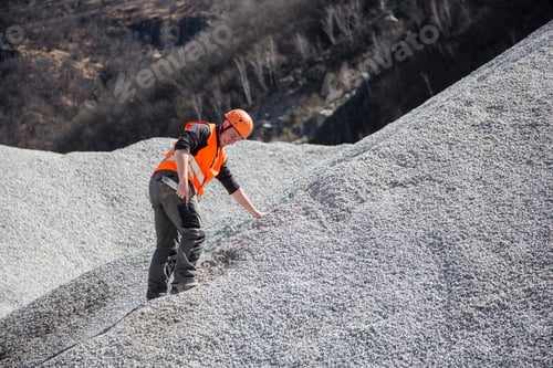 Preview: Quarry Worker Measuring On Gravel Mound At Quarry