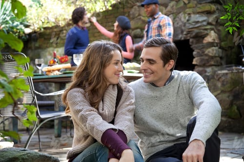 Preview: Smiling Couple Sitting Together Outdoors