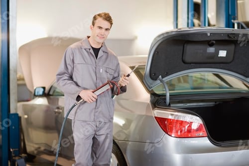 Preview: Mechanic Working On Car In Garage